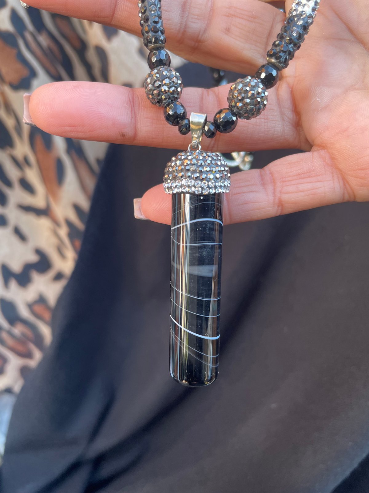 Black sardonyx tube with top crystals
