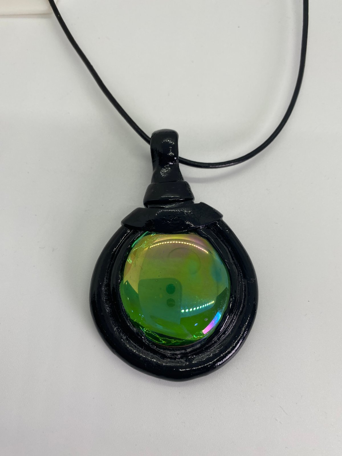 Black turtle with green glass stone