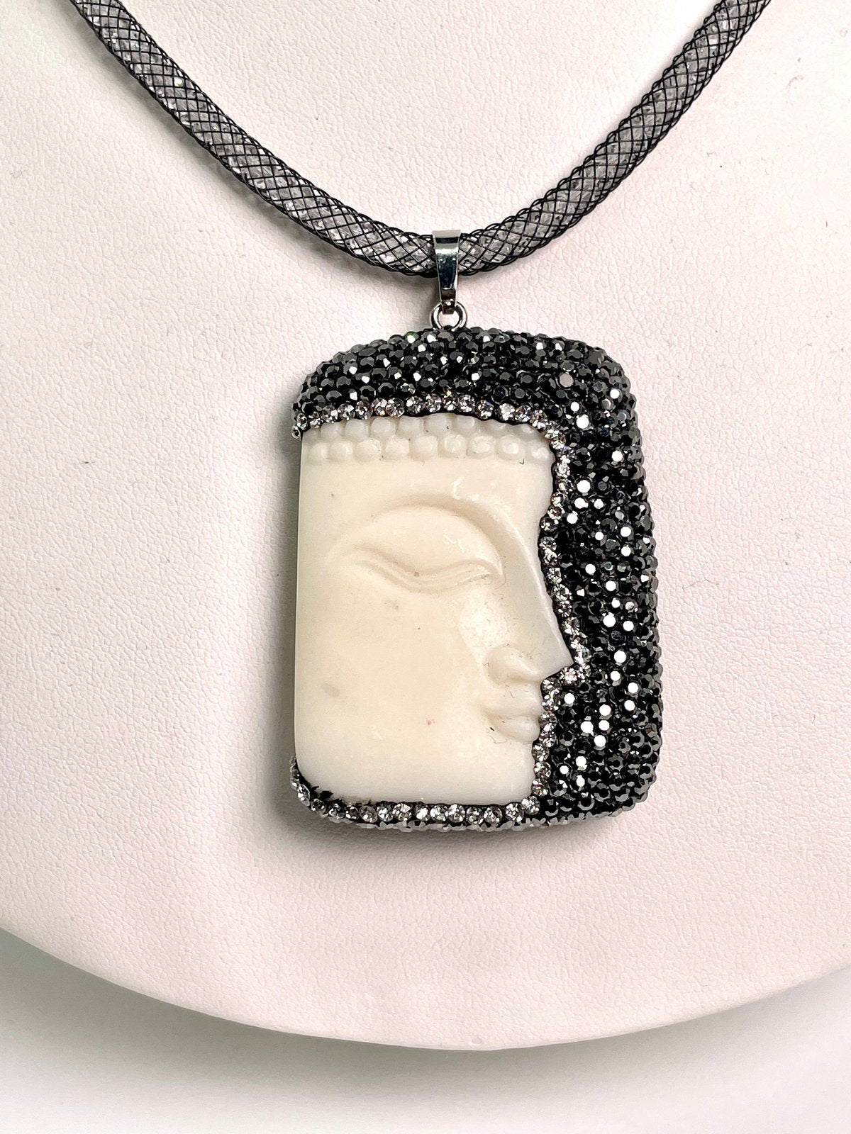 Cream/ivory Buddha face pendant with hematite crystals