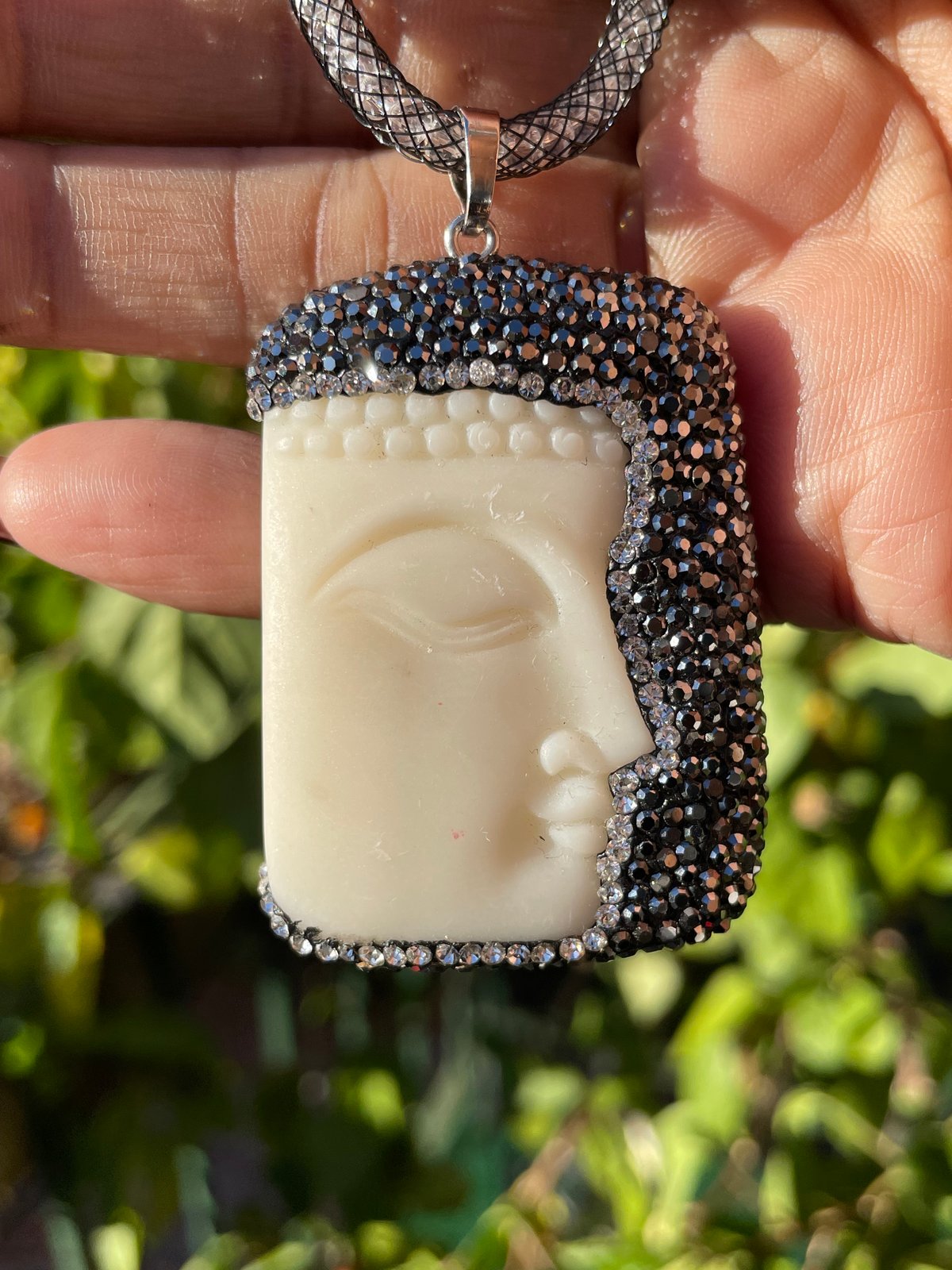 Cream/ivory Buddha face pendant with hematite crystals