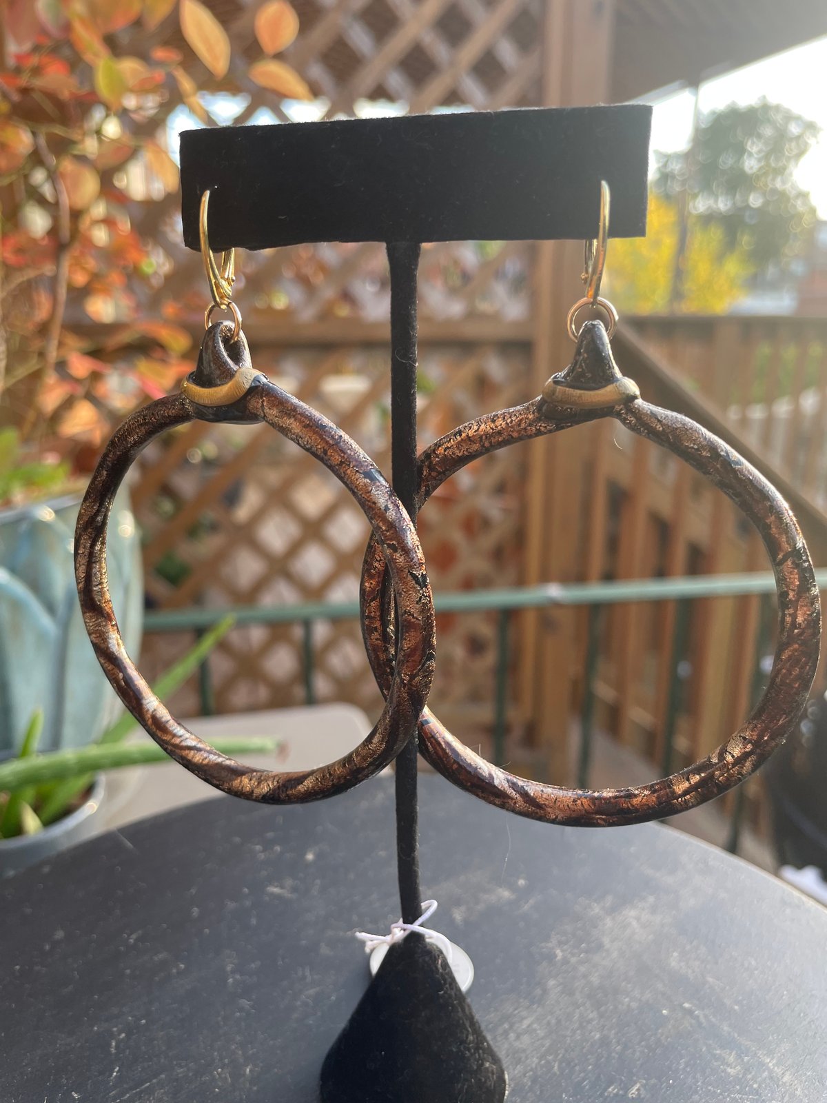 Marble brown thin large hoops with goal accent on gold lever backs