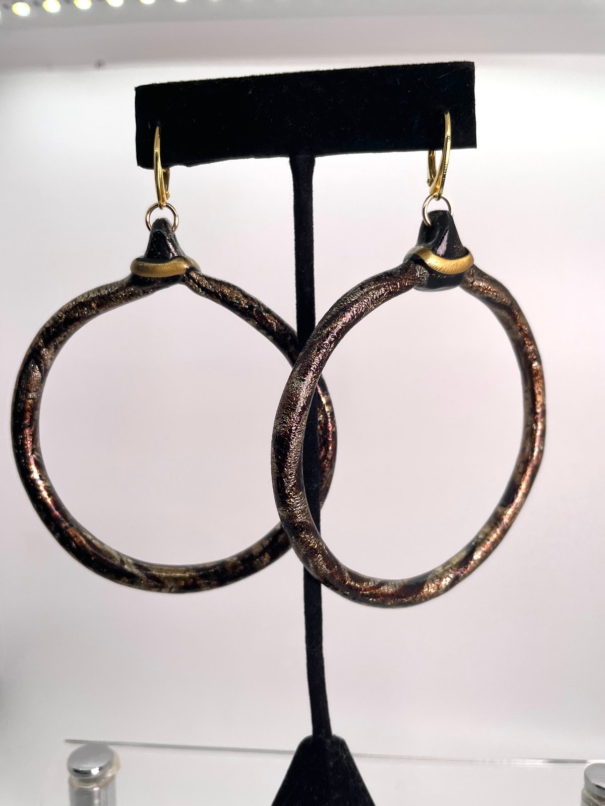 Marble brown thin large hoops with goal accent on gold lever backs
