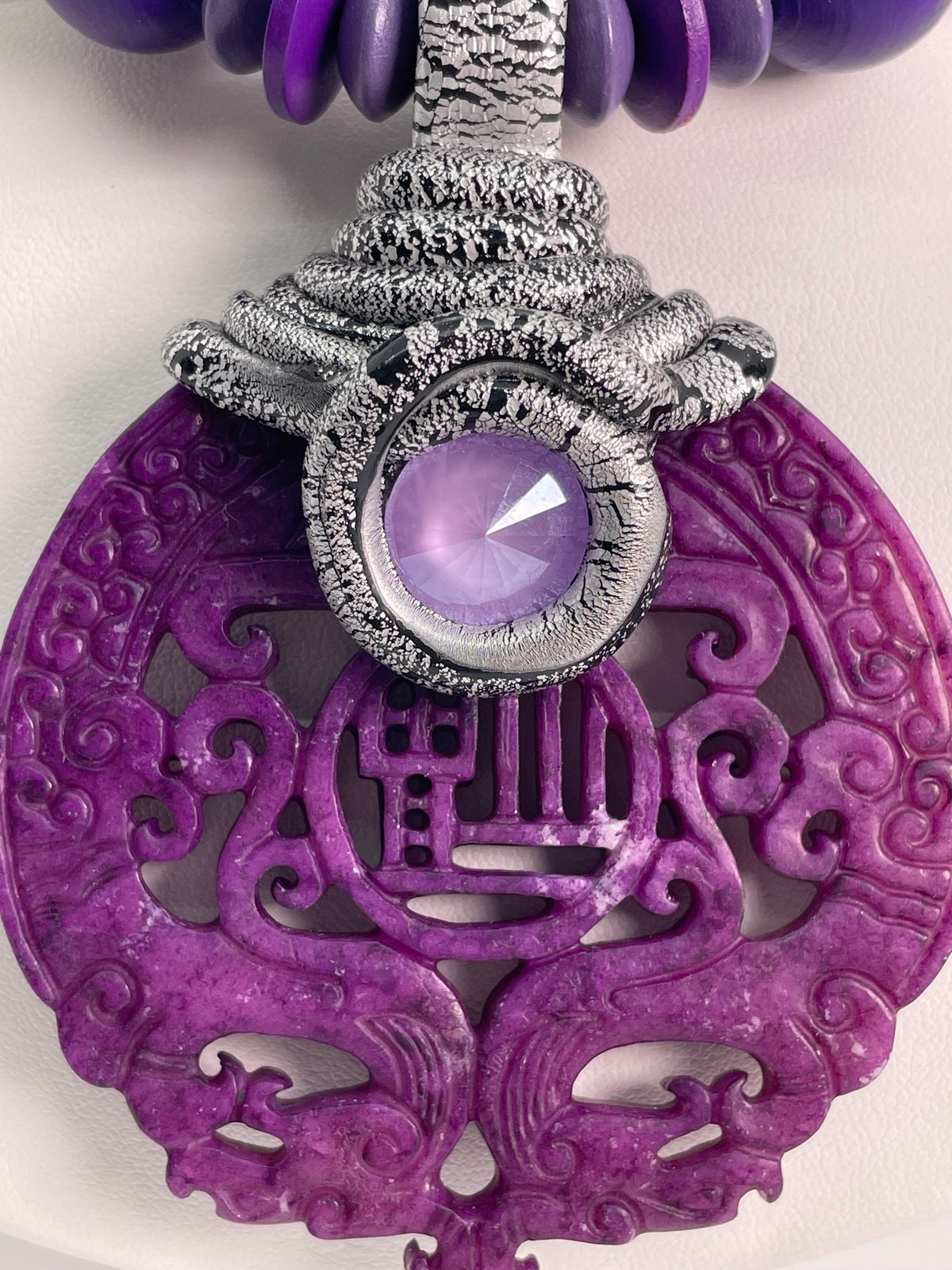 Purple carved Jade on cording